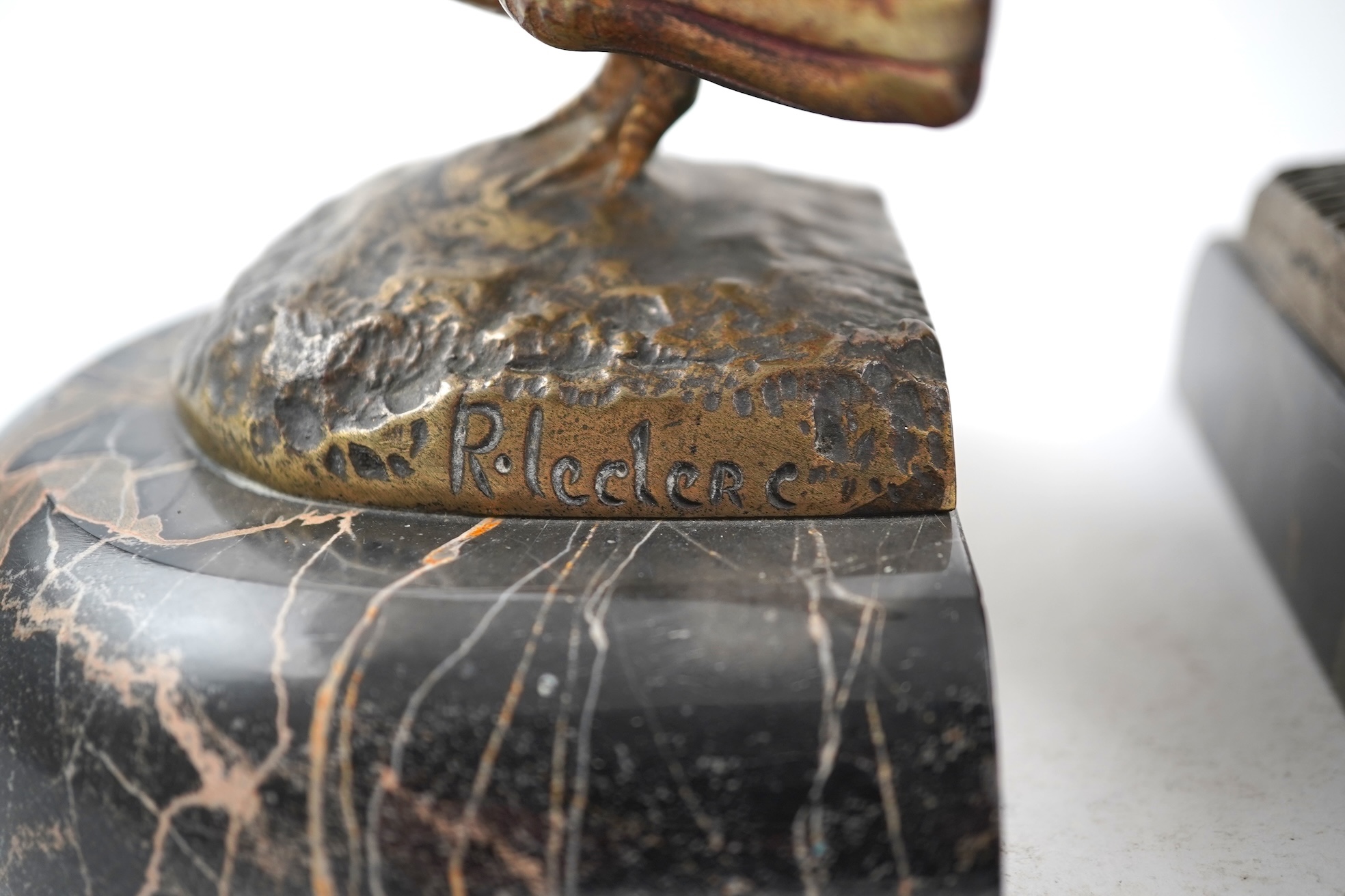 A pair of bronze peacock bookends, with remains of coloured pigments, marble plinths, signed R. Leclerc, 20cm